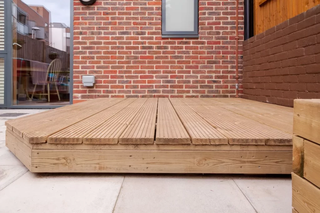 A newly built wooden deck in a back garden, highlighting the craftsmanship and potential unexpected costs.