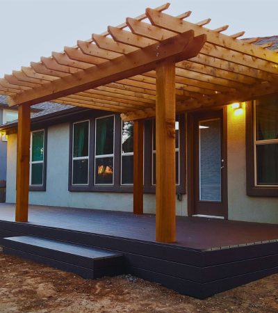 Cedar pergola integrated with custom deck design on Austin Hill Country lot