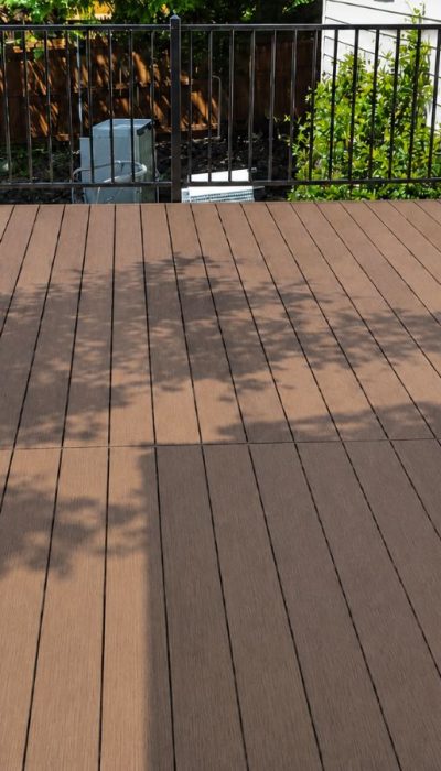 Finished composite deck installation on Austin home with railing complete